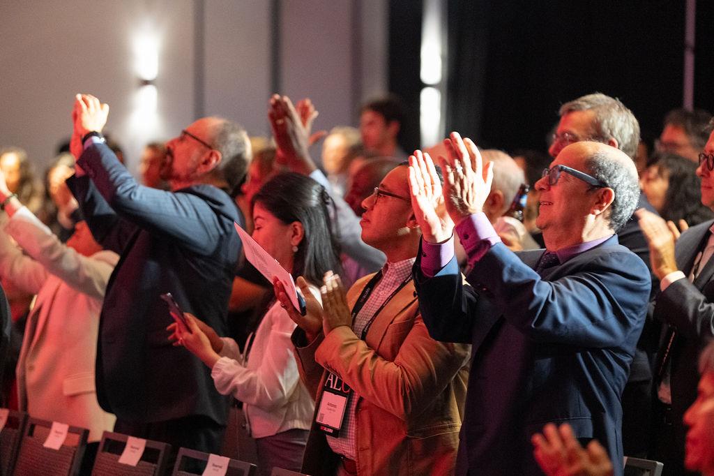 A group of ALC attendees standing and clapping at the Alumni Leadership Awards Celebration.